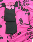 detail view of 40s pink top with black trim and ribbon style decoration