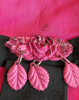 detail of dangly pink plastic pin