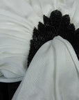 close up detail, beaded accent at hip draping of 80s jumpsuit