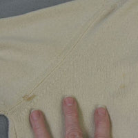close up of small stain on left side of sweater back near underarm