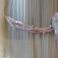 close up of knotted ribbon trim at dropped waist