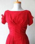 detail view of bodice, red velvet dress, tucked and ruched