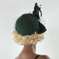back view, 40s 50s dark green hat with feathers and swag