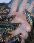 close up detail, flame shaped beading over sheer cleavage