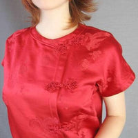 closeup of 60s red Asian top with ornate frog closures