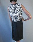 back view, 60s black sheath with extensive white beading and bling