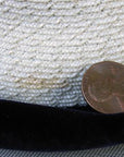 closeup of small flaw on straw of hat