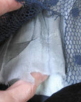 close up of deteriorated middle layer of gossamer fabric inside sleeve