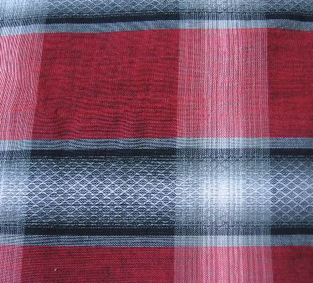 close up detail of novelty weave plaid fabric red gray white black