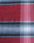 close up detail of novelty weave plaid fabric red gray white black