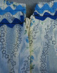 closeup detail floral blue and whie print with rick rack