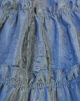close up. areas of decreased flocking on tiered ruffled skirt