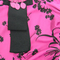 detail view of 40s pink top with black trim and ribbon style decoration