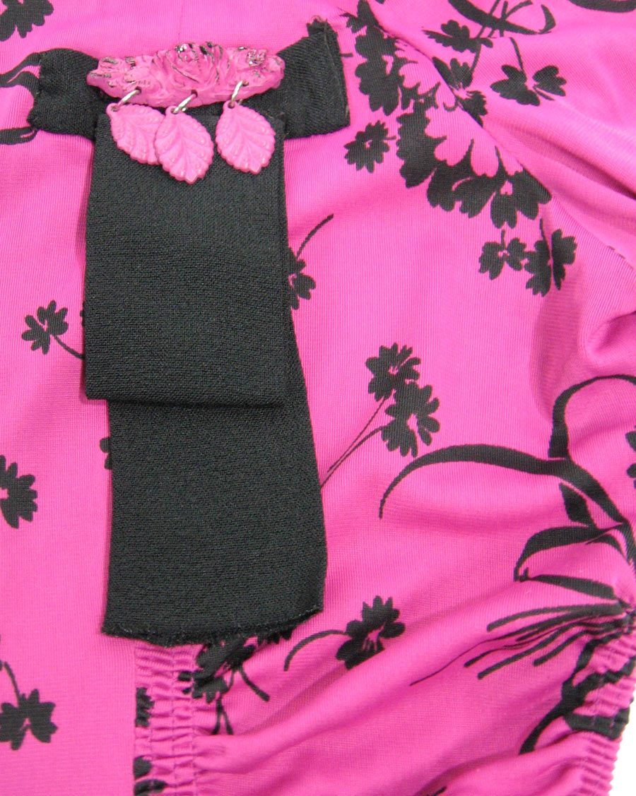 detail view of 40s pink top with black trim and ribbon style decoration