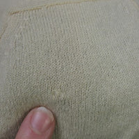 close up detail, small old repair to cashmere near shoulder