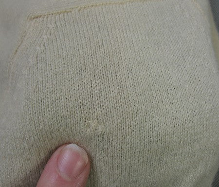 close up detail, small old repair to cashmere near shoulder