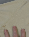 close up of small stain on left side of sweater back near underarm