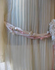 close up of knotted ribbon trim at dropped waist