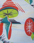 closeup of atomic kitsch print in tomato red, avocado green, and dark teal