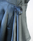 close-up detail draped skirt and sash