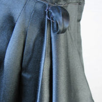 close-up detail draped skirt and sash