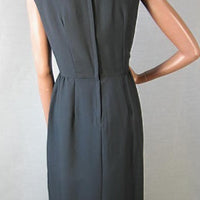 back view, 1960s black sleeveless sheath office to cocktail