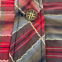 close up detail plaid fabric and hashtag buttons