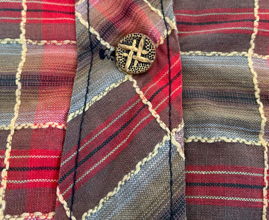 close up detail plaid fabric and hashtag buttons