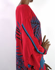 side view of kimono sleeves on 80s red silk dress