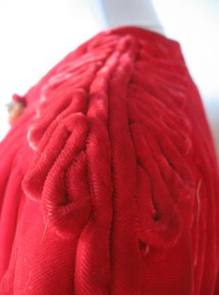 close up detail, cording embellishment at shoulders of 40s red velvet jacket