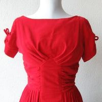 detail view of bodice, red velvet dress, tucked and ruched