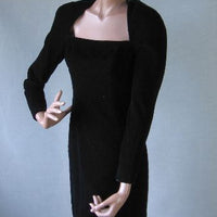 1980s black velvet cocktail dress with strong shoulders