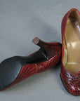 overhead view of rounded toe snakeskin pumps, heels and sole