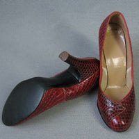 overhead view of rounded toe snakeskin pumps, heels and sole