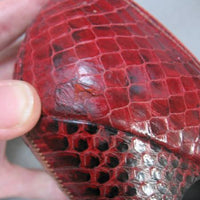close up of old repair, red snakeskin pumps
