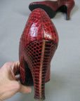 closeup view of red snakeskin heel from back 