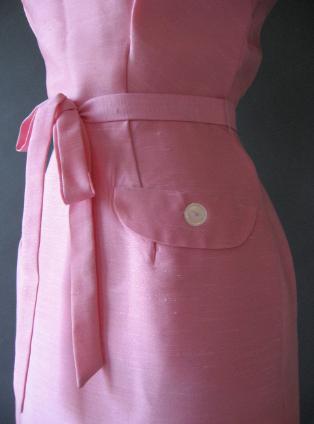 waist detail, sash and big button pocket flap of pink 50s day dress