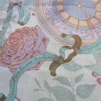 close up detail of de la Renta scarf, roses and clocks 