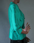 side view, green silk fit and flare 50s jacket