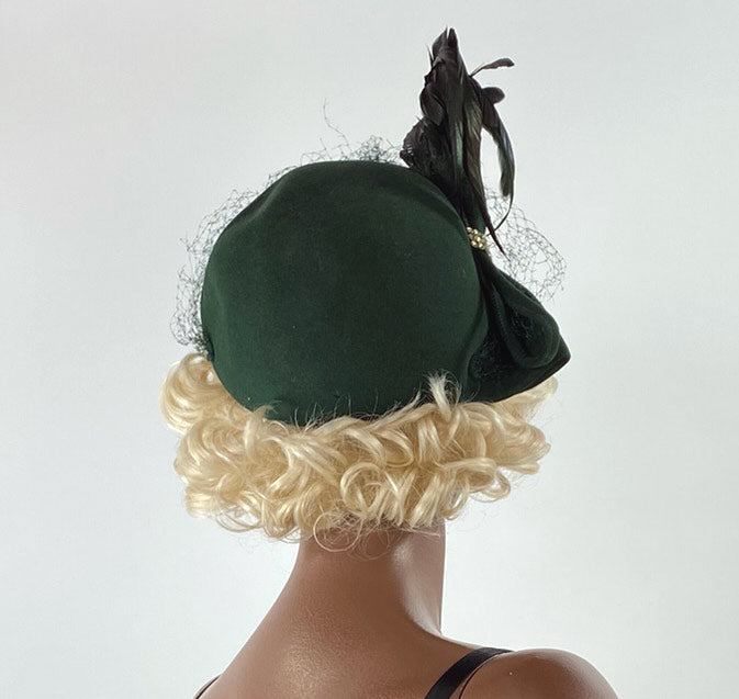 back view, 40s 50s dark green hat with feathers and swag