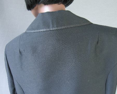 close up detail of jacket back, braid edged collar