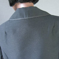 close up detail of jacket back, braid edged collar