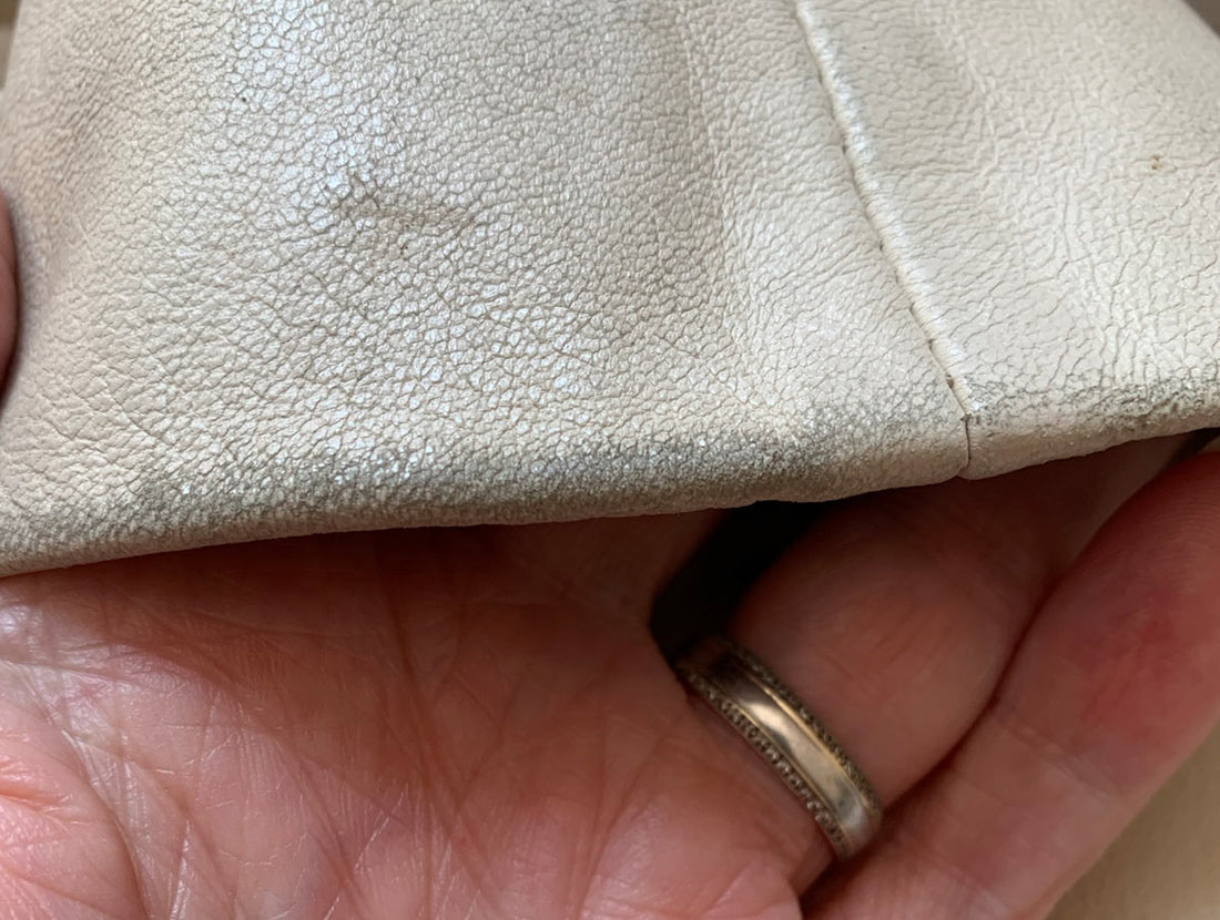 close up of minor leather scuffing at bottom of sleeve