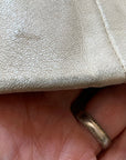 close up of minor leather scuffing at bottom of sleeve