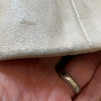 close up of minor leather scuffing at bottom of sleeve