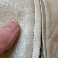 close up of small pen mark to leather on vintage jacket