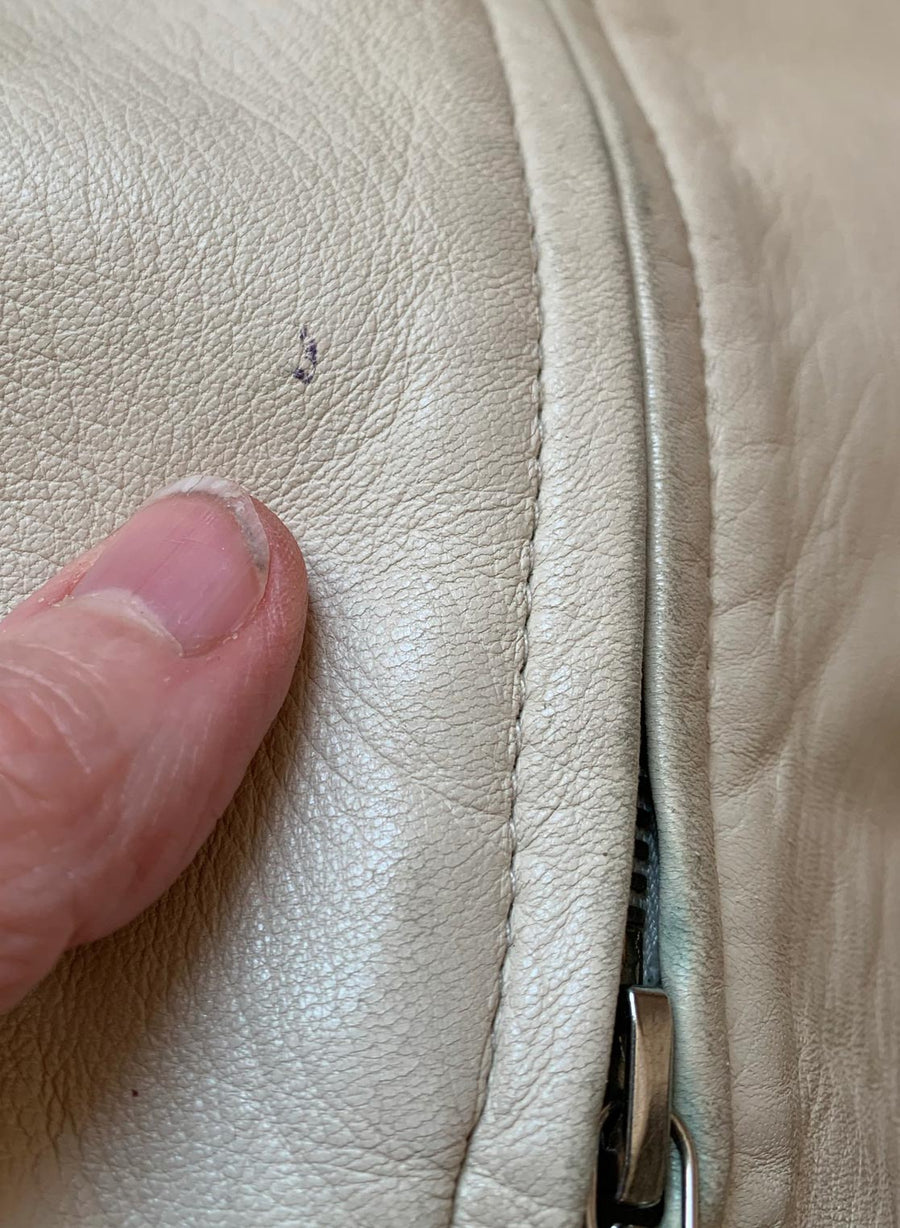 close up of small pen mark to leather on vintage jacket