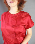 closeup of 60s red Asian top with ornate frog closures