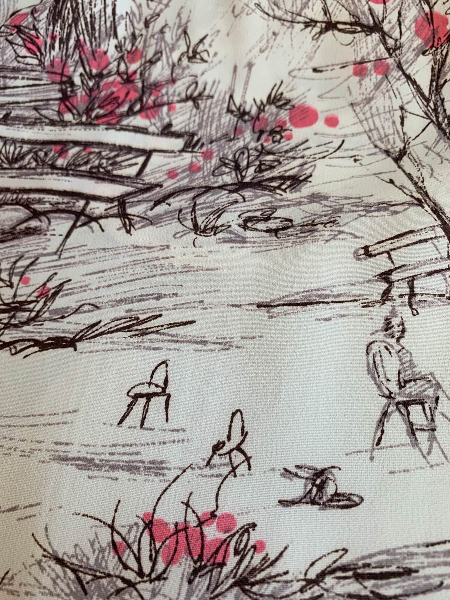 close up of novelty print, park bench, flowering bushes