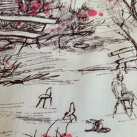 close up of novelty print, park bench, flowering bushes